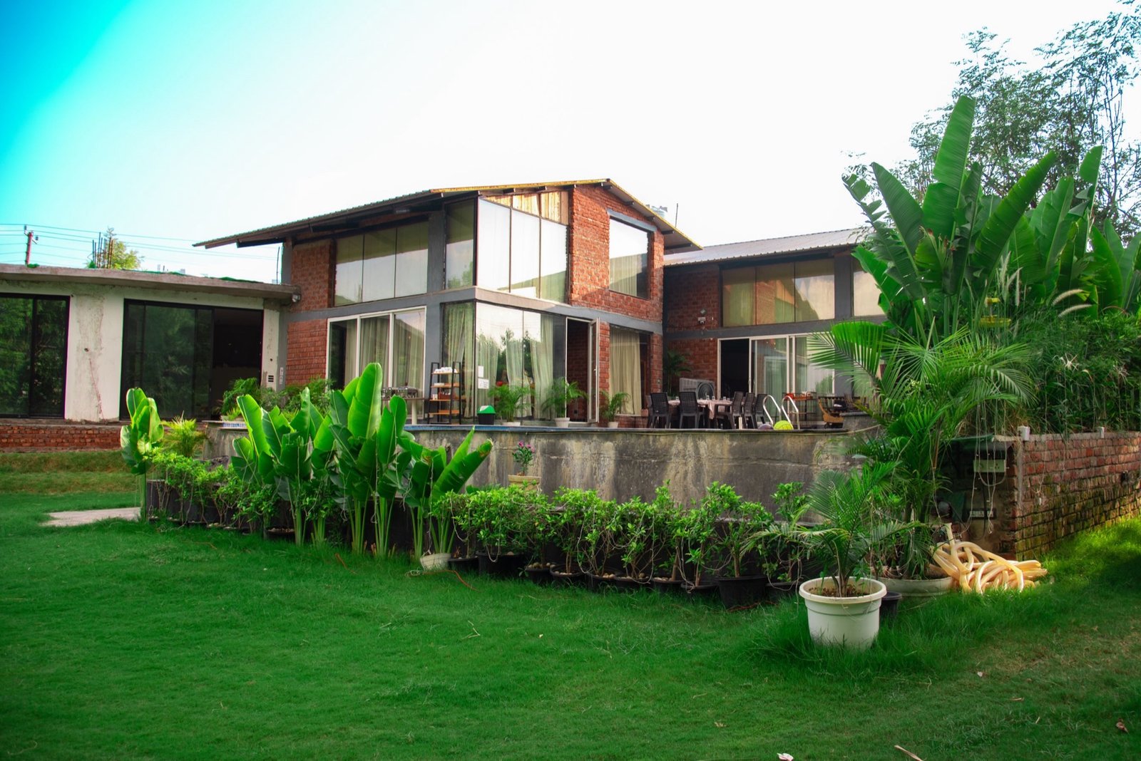 We Woods Farm exterior — luxury farmhouse in Gurgaon, Manesar with private pool and green garden