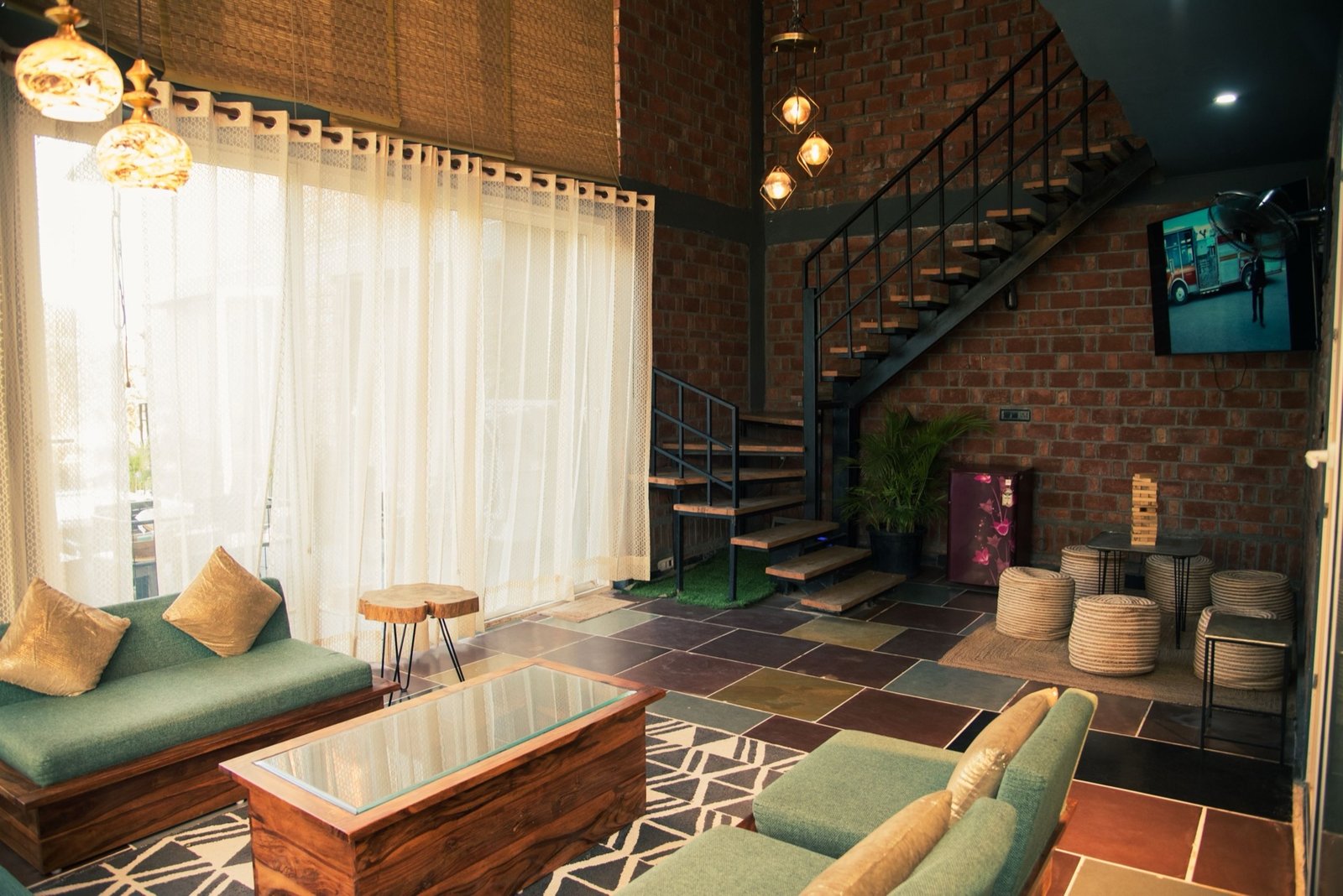 Bright living room with floor-to-ceiling windows — We Woods Farm farmhouse Gurgaon